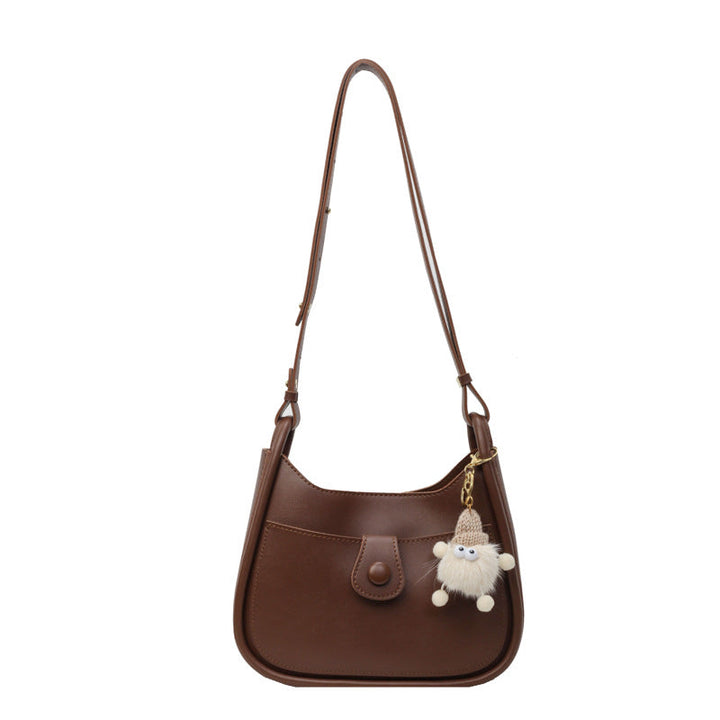 Women's shoulder bag made of high-quality synthetic leather with playful charm