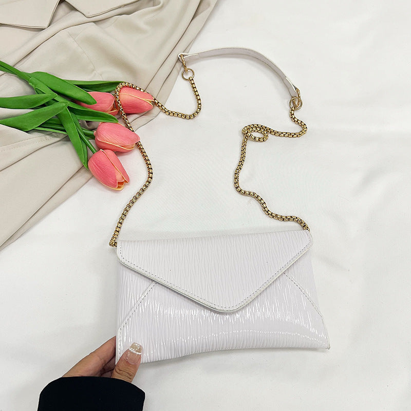 Women's elegant clutch with shiny upper material