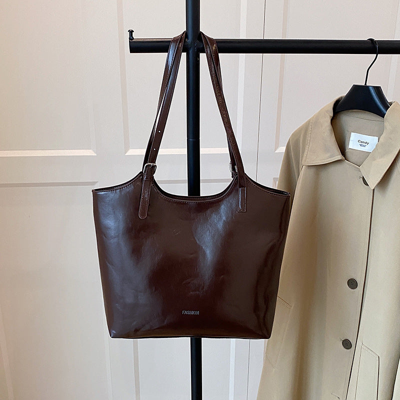Ladies elegant tote handbag made of high-quality synthetic leather with playful pendant