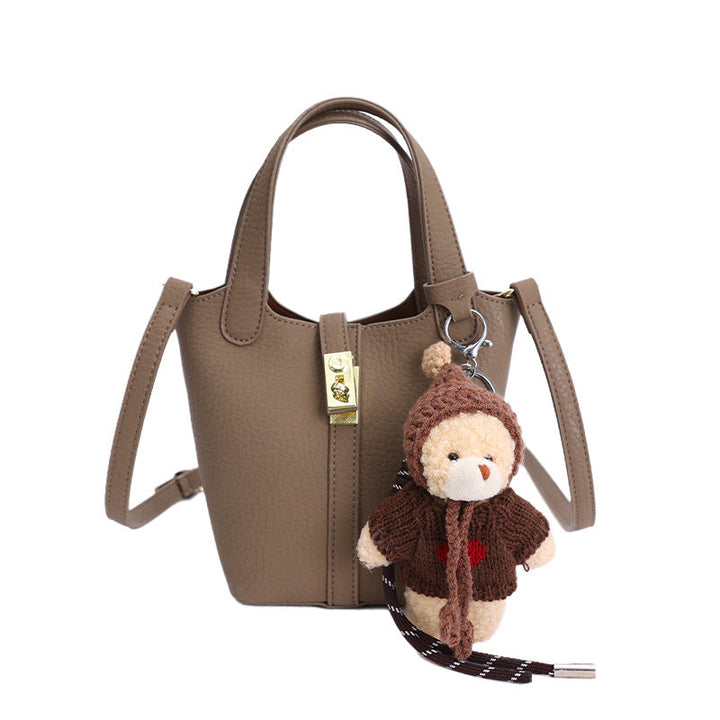 Women's mini handbag with playful animal charm