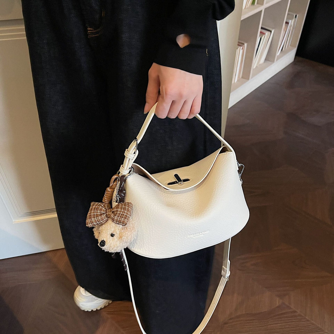 Women's shoulder bag with charming pendant and elegant design