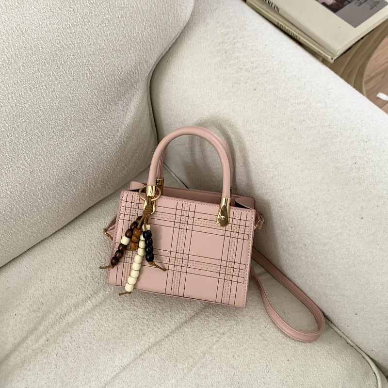 Women's mini handbag with elegant structure and golden accents