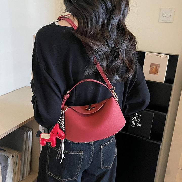 Women's shoulder bag with charming pendant and elegant design