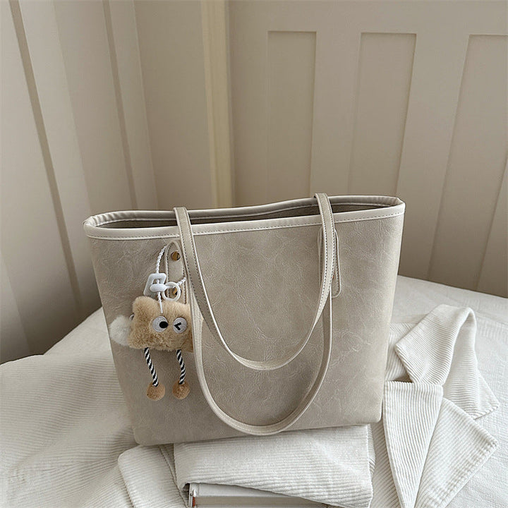 Women's classic tote bag with charming plush toy pendant