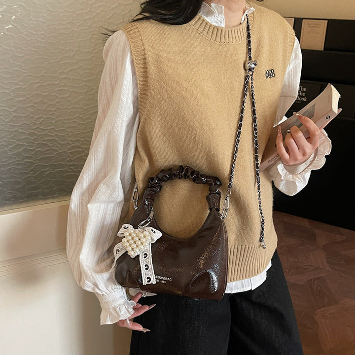 Ladies mini handbag with voluminous ruffle design and trendy charms