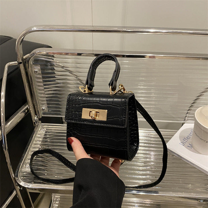 Ladies mini bag with elegant crocodile look and golden accents