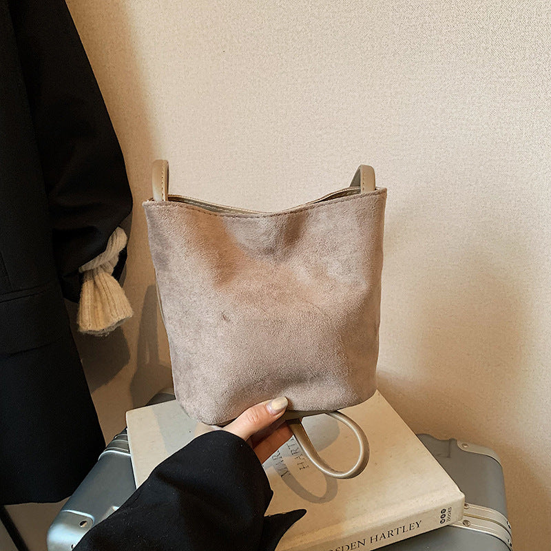 Women's mini bag made of soft suede with adjustable shoulder strap