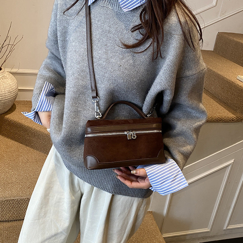 Women's shoulder bag made of soft suede leather with practical compartments