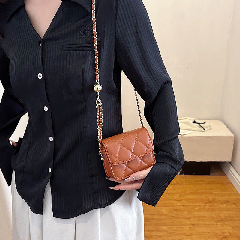 Women's mini crossbody bag with shiny chain and charming pendant