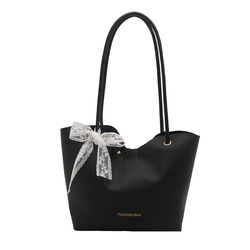 Women’s tote bag made of high-quality synthetic leather with playful bow detail