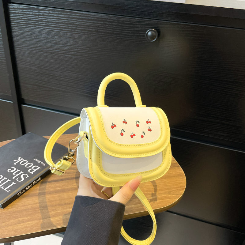 Women's mini handbag with cheerful cherry design and charming pendants