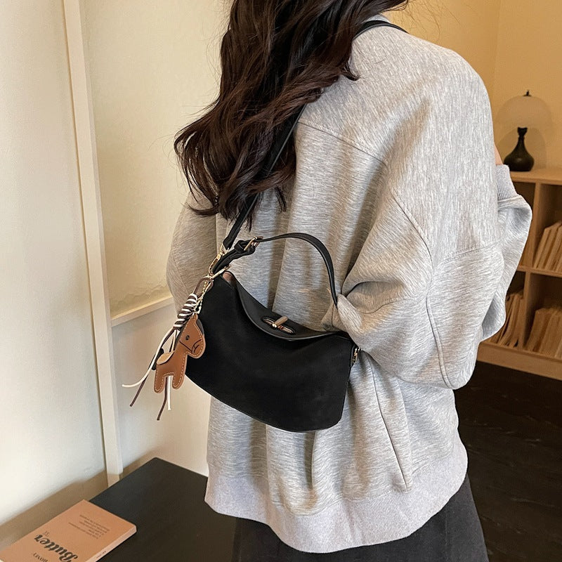 Women's shoulder bag with charming pendant and elegant design