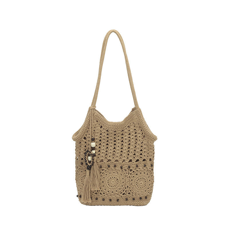 Ladies crocheted shoulder bag with decorative fringes and unique accents