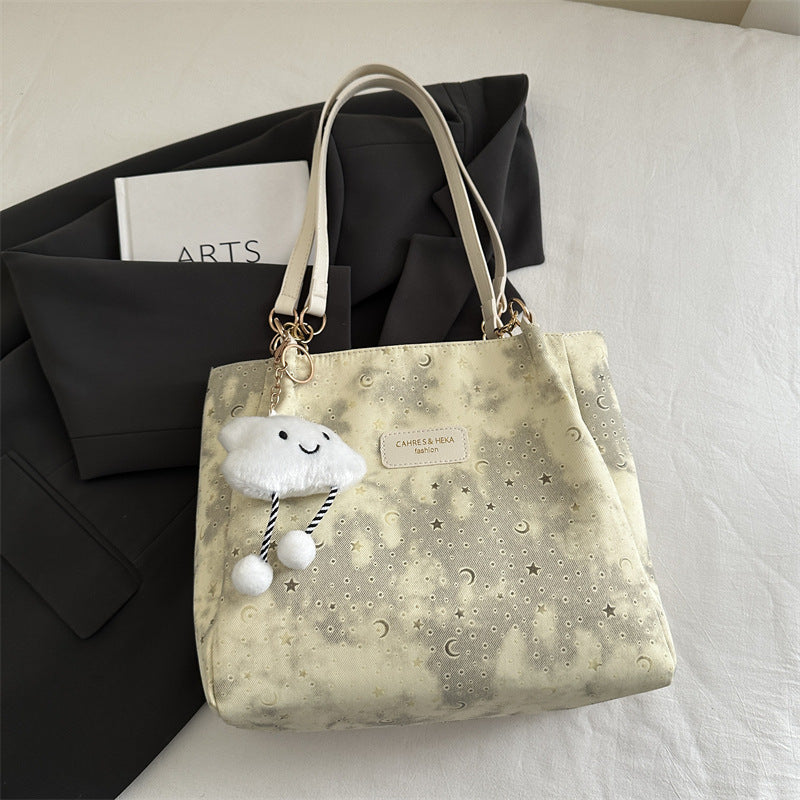 Women’s stylish tote bag with playful pendant