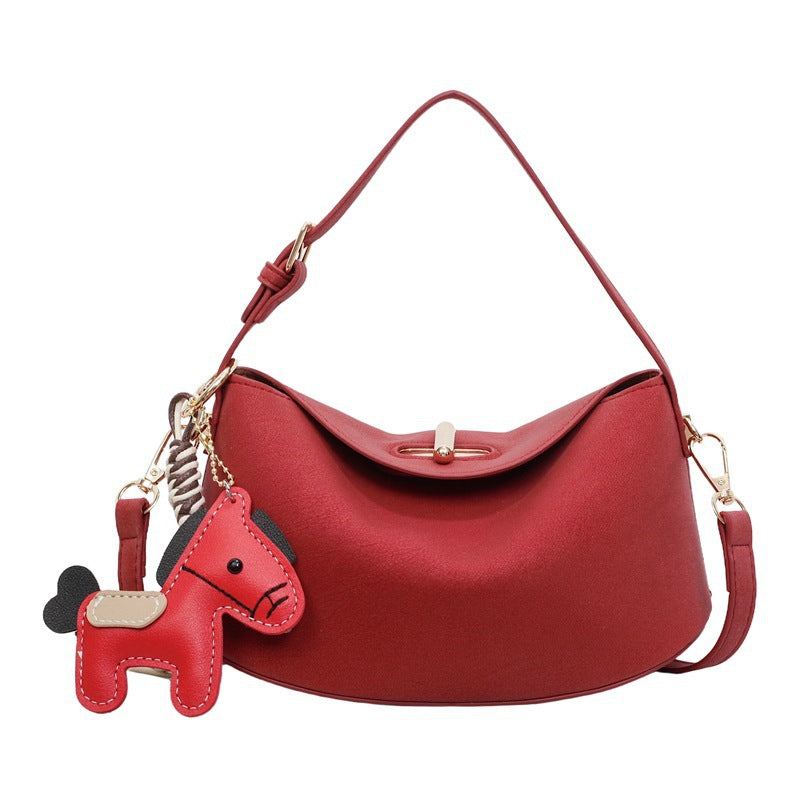 Women's shoulder bag with charming pendant and elegant design