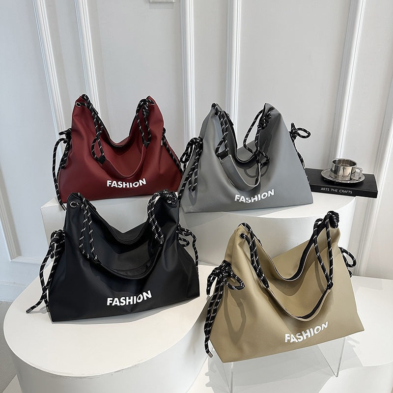Women's stylish tote bag with braided drawstring