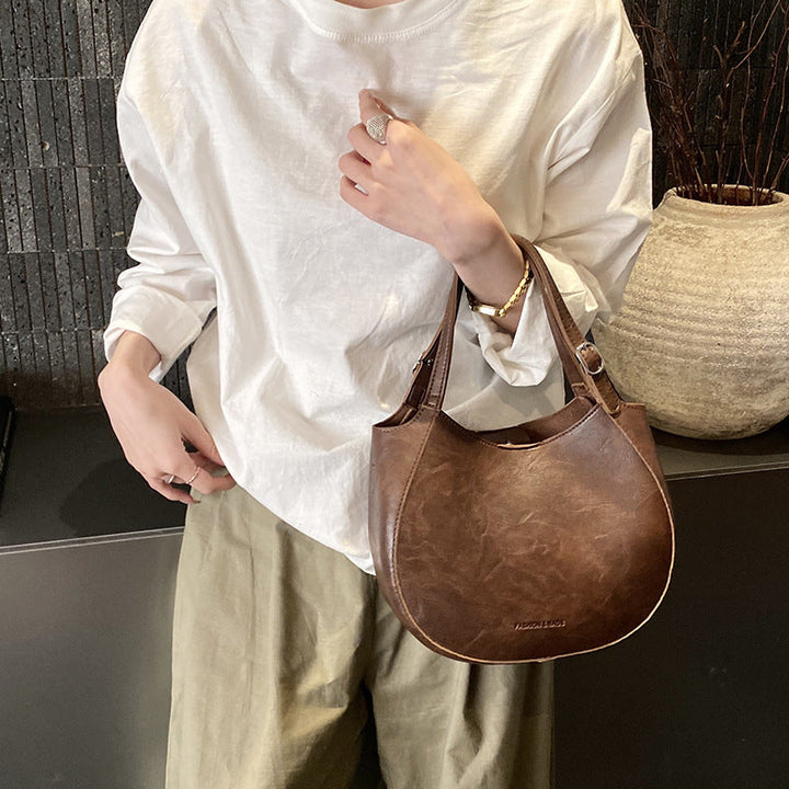 Women's shoulder bag made of high-quality artificial leather with fashionable trim