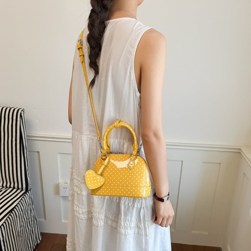 Women’s mini handbag with playful polka dot pattern and detachable shoulder strap