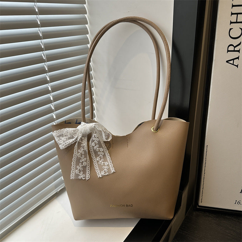 Women’s tote bag made of high-quality synthetic leather with playful bow detail