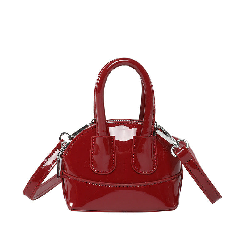 Ladies mini handbag with elegant glossy finish and removable shoulder strap