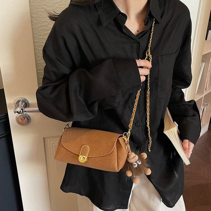Women's shoulder bag with decorative pendant and luxurious chain strap