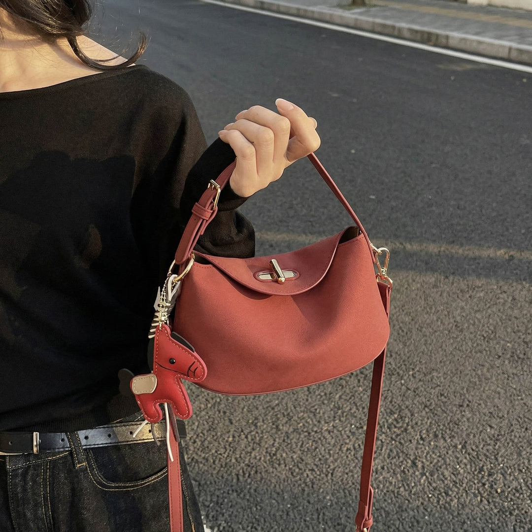Women's shoulder bag with charming pendant and elegant design