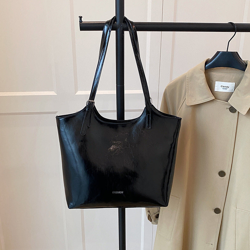 Ladies elegant tote handbag made of high-quality synthetic leather with playful pendant