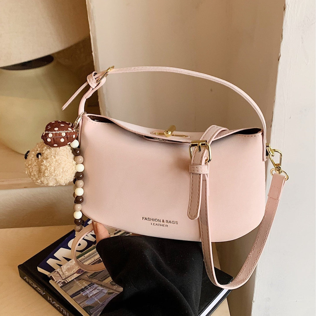 Women's shoulder bag with decorative pendant