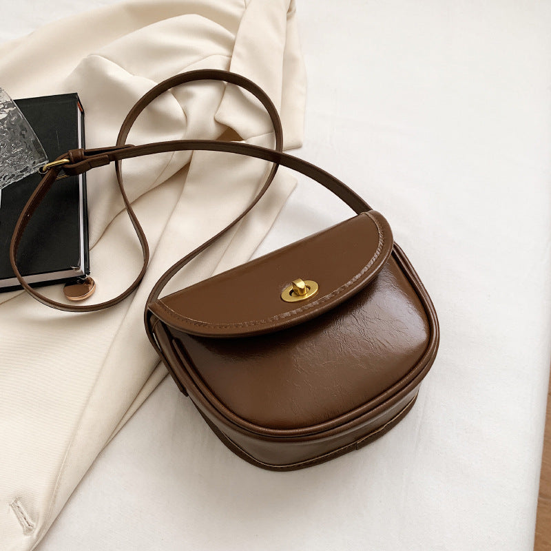Women's shoulder bag in elegant retro design with golden accents