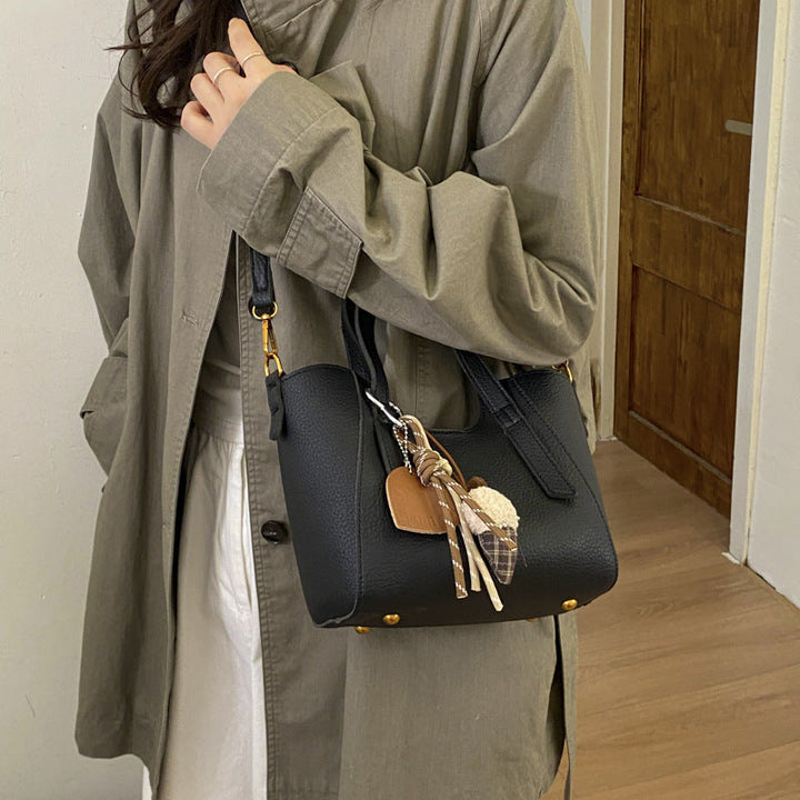 Women's mini handbag in an elegant design with charming pendant