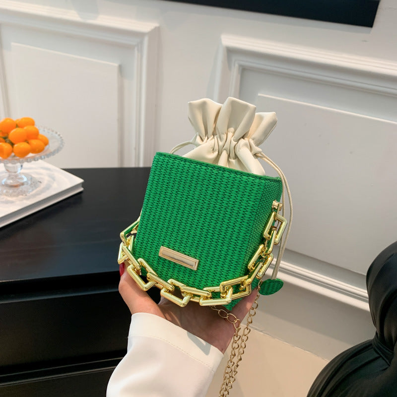 Women's mini handbag with unique chain embellishment and classic drawstring