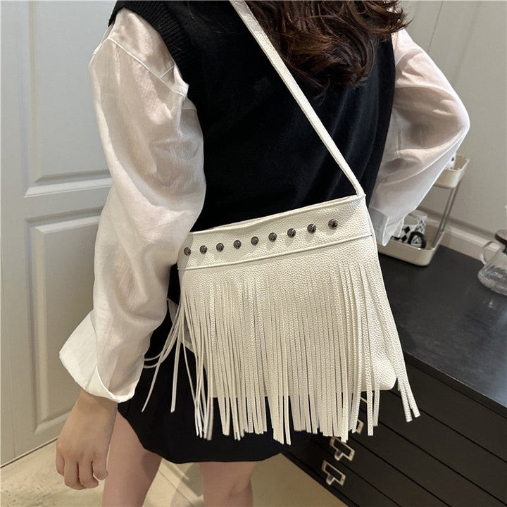 Ladies shoulder bag with fringes and studs