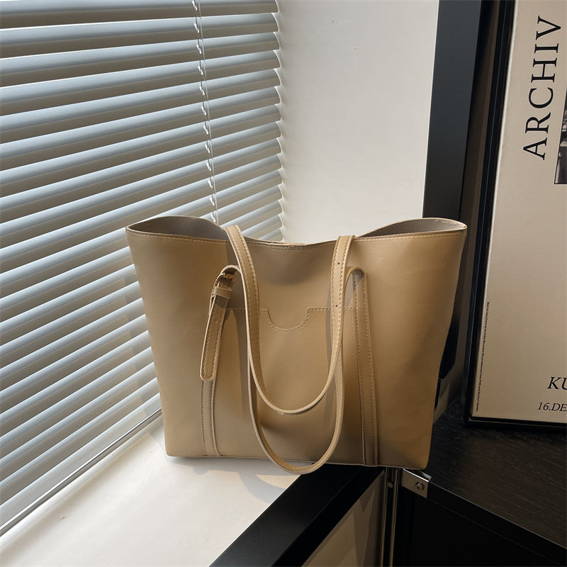 Women's tote bag made of structured synthetic leather with stylish detail