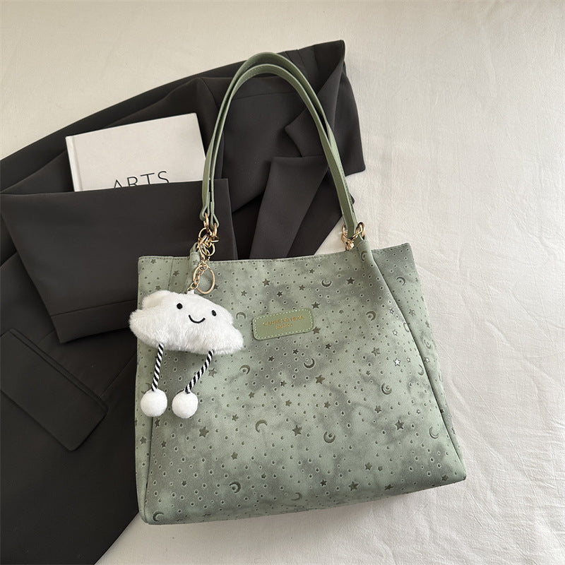 Women’s stylish tote bag with playful pendant