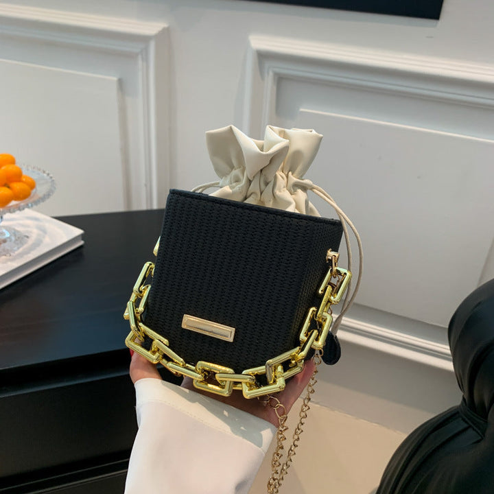 Women's mini handbag with unique chain embellishment and classic drawstring