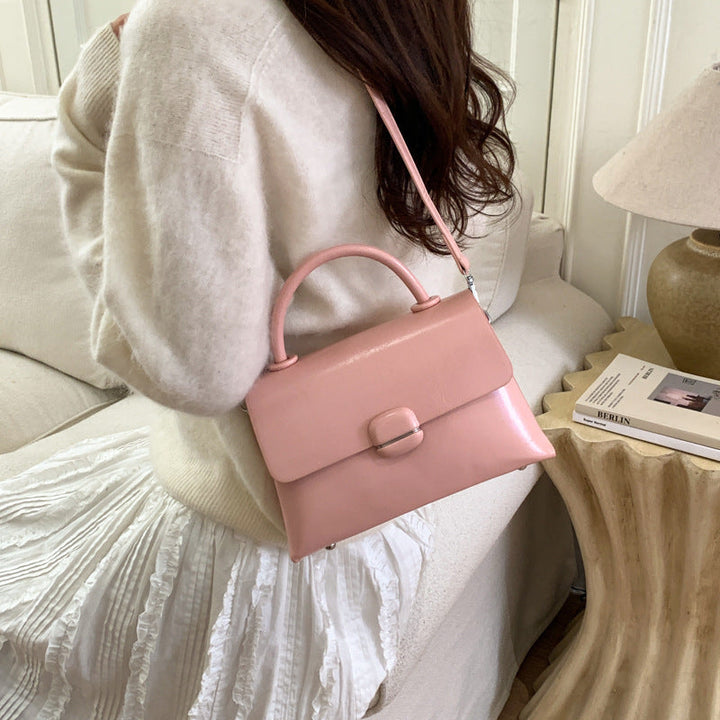 Women's handbag with textured design and elegant closure