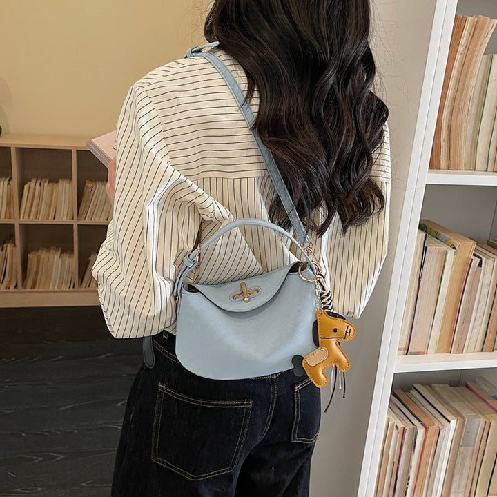 Women's shoulder bag with charming pendant and elegant design