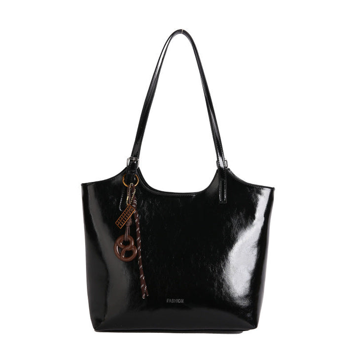 Ladies elegant tote handbag made of high-quality synthetic leather with playful pendant