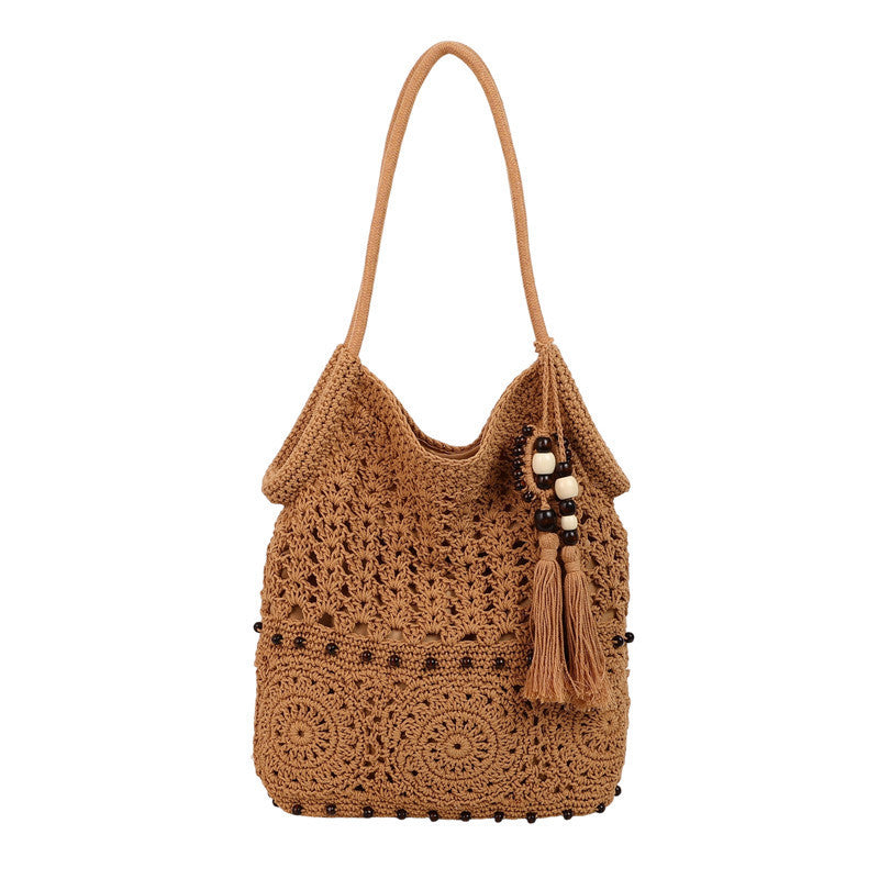 Ladies crocheted shoulder bag with decorative fringes and unique accents