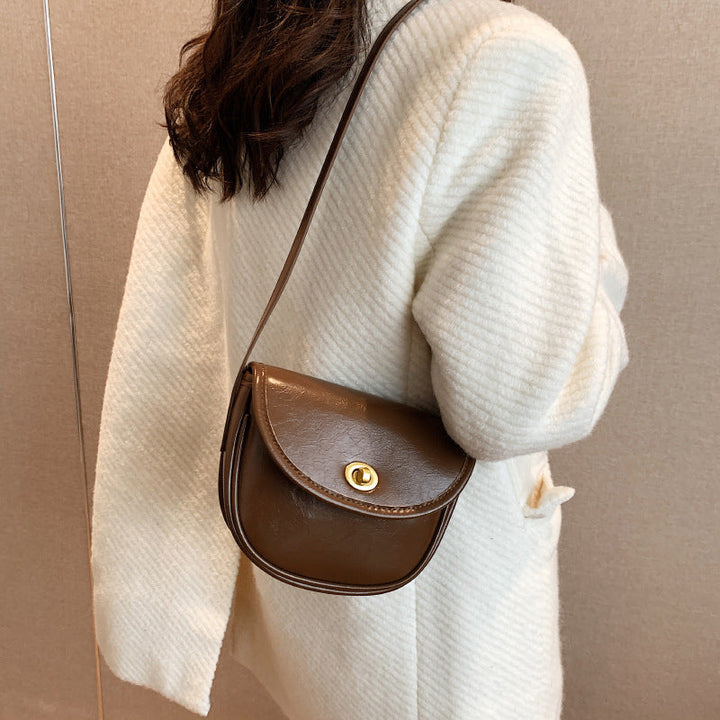 Women's shoulder bag in elegant retro design with golden accents