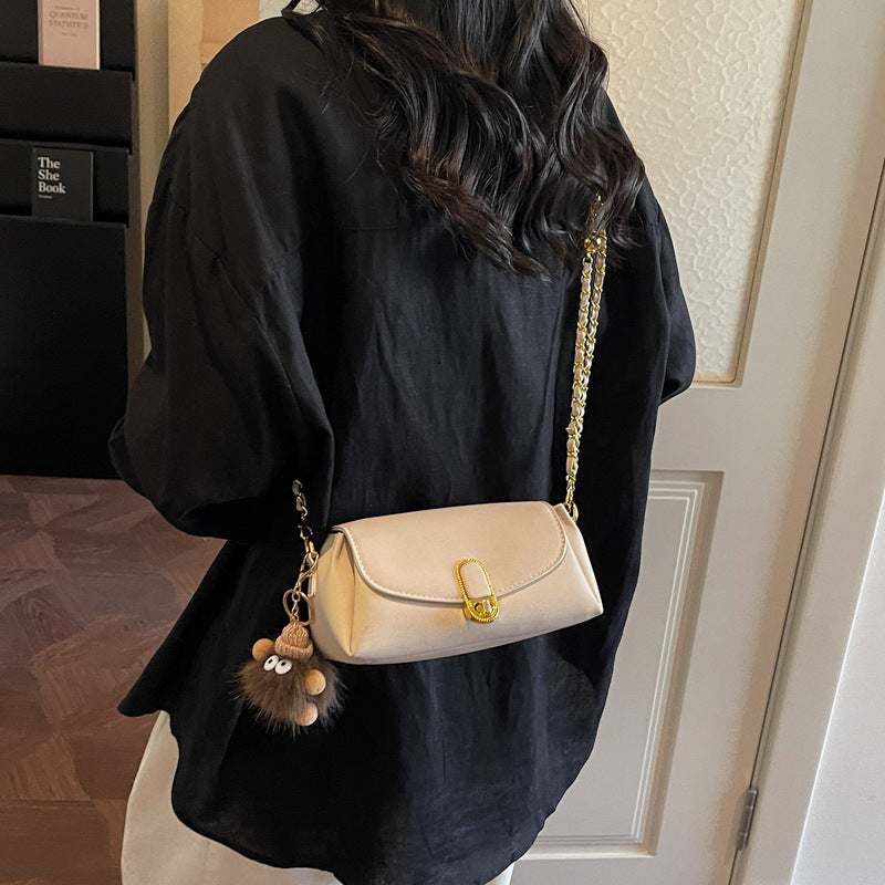 Women's shoulder bag with decorative pendant and luxurious chain strap