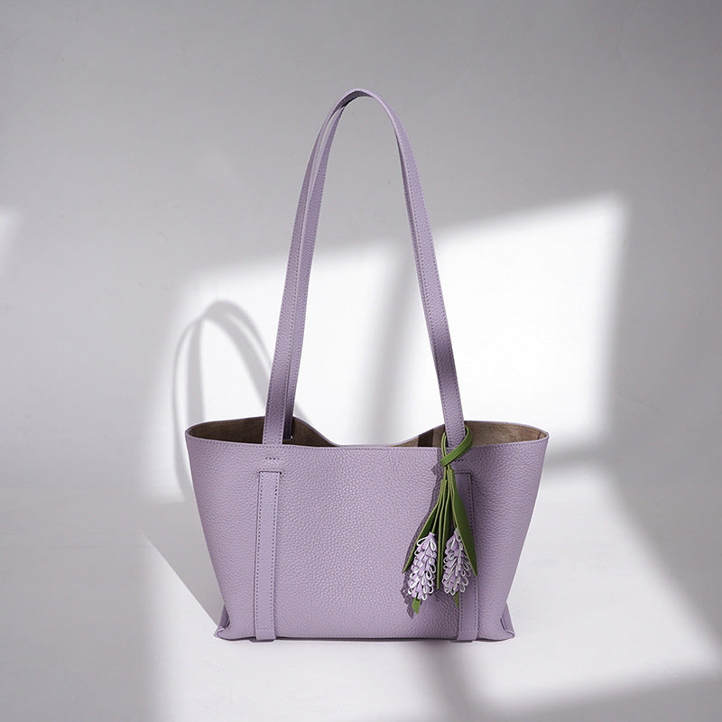 Ladies stylish tote bag with floral pendant