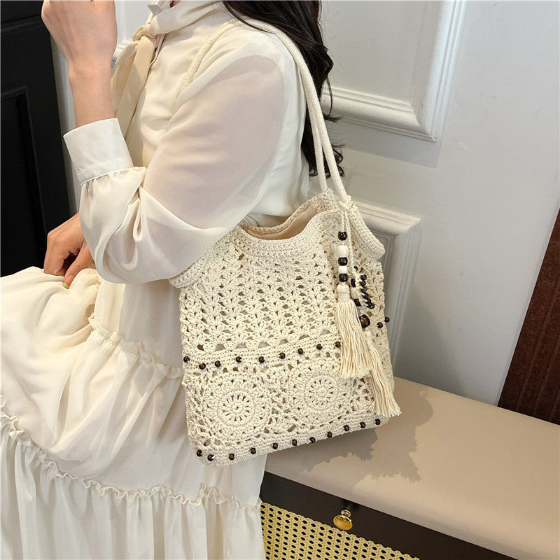 Ladies crocheted shoulder bag with decorative fringes and unique accents