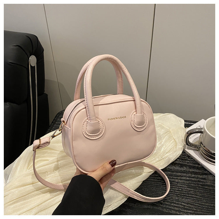 Ladies fashionable handbag with elegant pull handles and removable shoulder strap