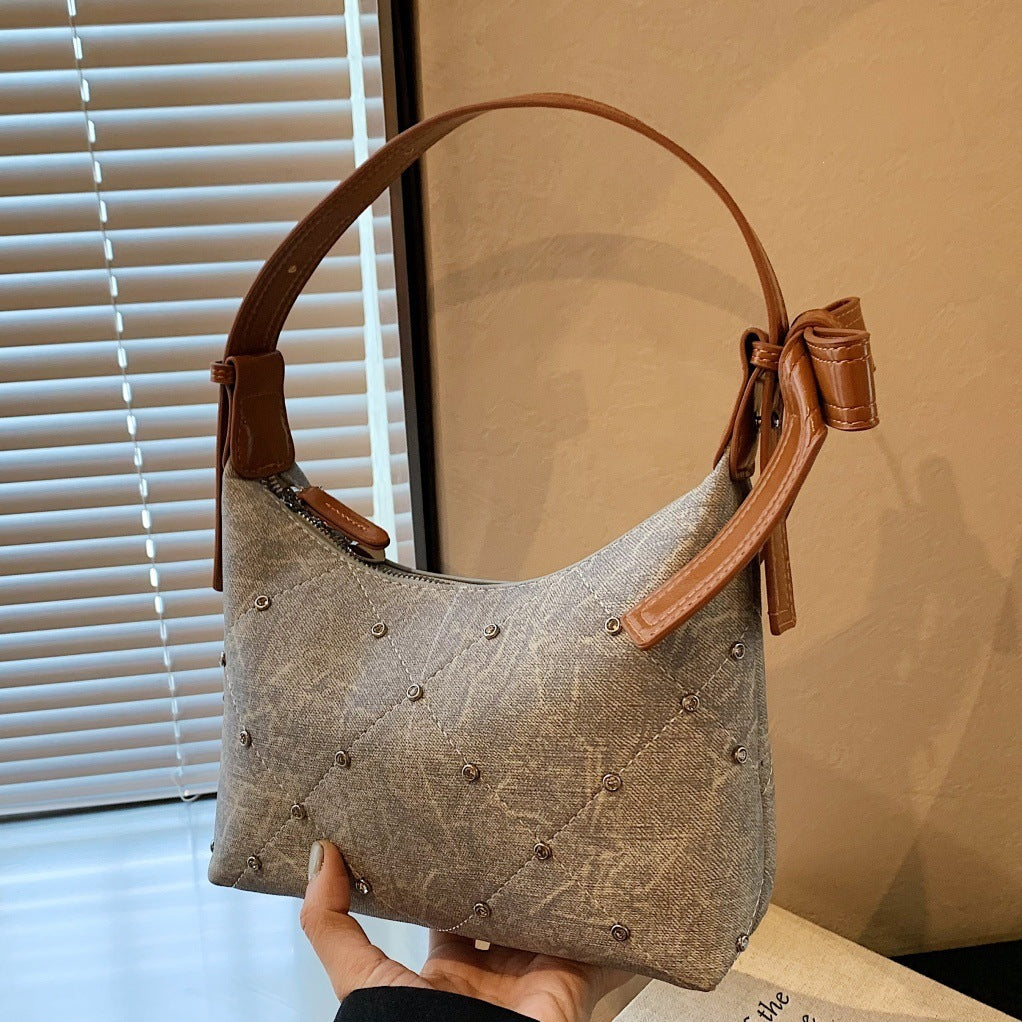 Ladies fashionable shoulder bag with sparkling appliqués