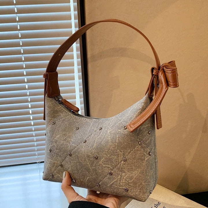 Ladies fashionable shoulder bag with sparkling appliqués