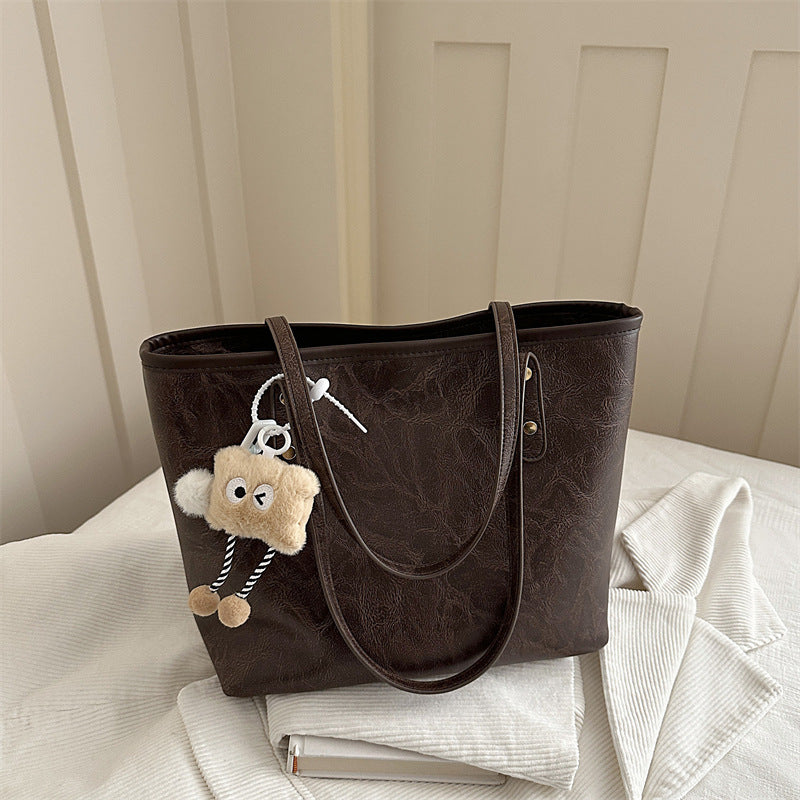 Women's classic tote bag with charming plush toy pendant