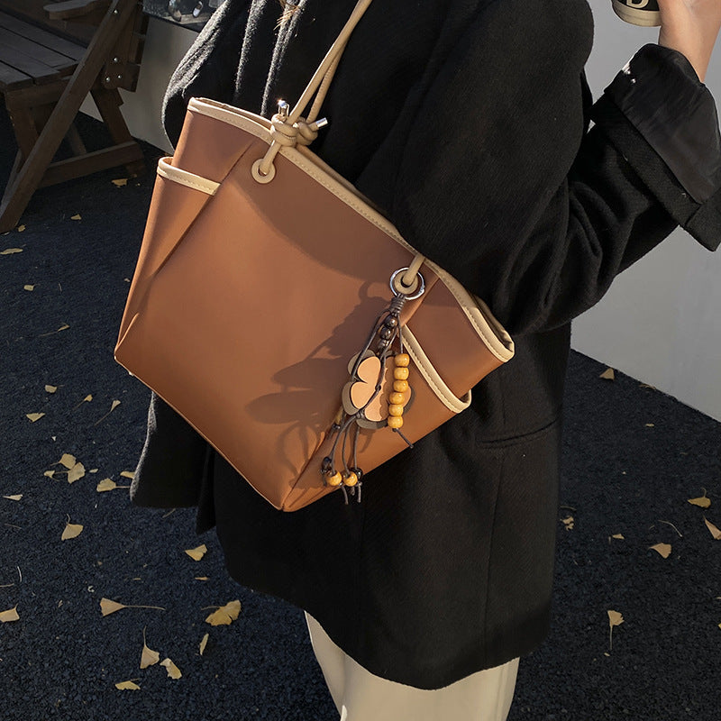 Women's practical shoulder bag with charming appliqués