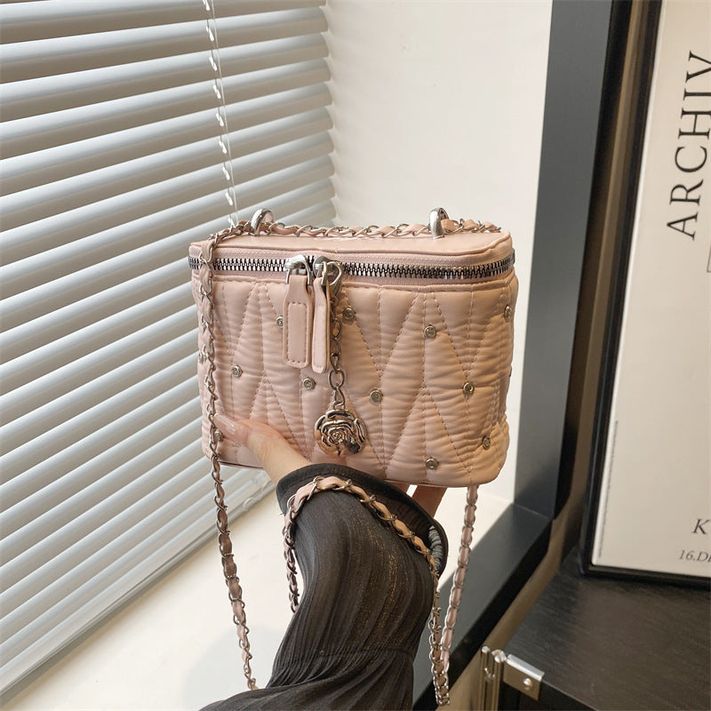 Women's mini handbag with elegant quilting and chain pendant