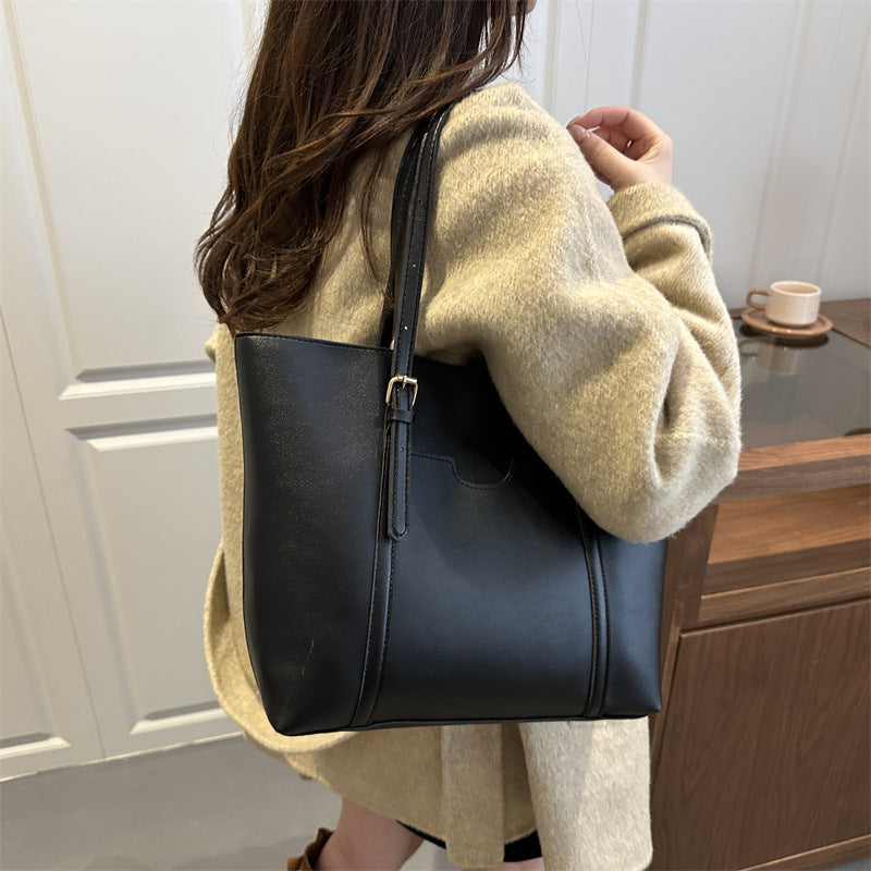 Women's tote bag made of structured synthetic leather with stylish detail